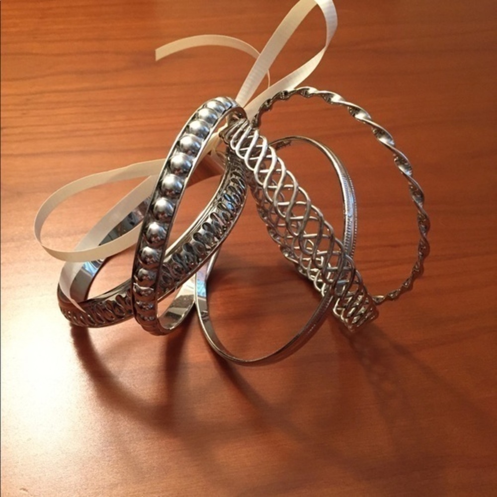 Five silver tone bangles